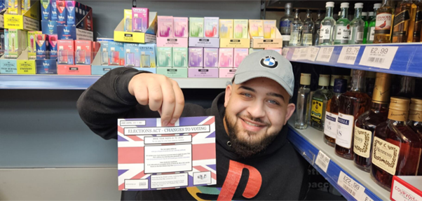 A man holding an information leaflet on voting changes