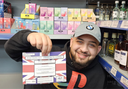 A man holding an information leaflet on voting changes